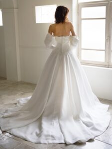 MK-012（オフホワイト）| 独特のとろみがあるトリアセテートミカドをふんだんに使ったAラインのシンプルドレス。スカートの接ぎ線を少なくし、生地の落ち感がスカートのシルエットに表現されるようなカッティングにしました。前中心から後ろにかけて切り替え位置を低くした変形ドロップウエストで、前中心は下にすっきり落ちるデザインでお腹のふくらみをカバーし、脇からボリュームを出すことで華奢なウエストを強調するパターンにこだわった１着です